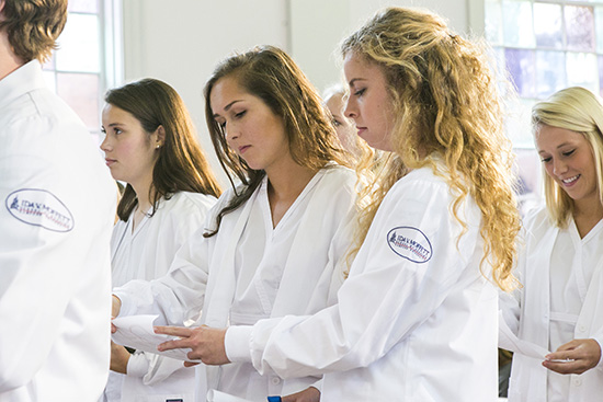 Young women participating in Nursing White Coat ceremony