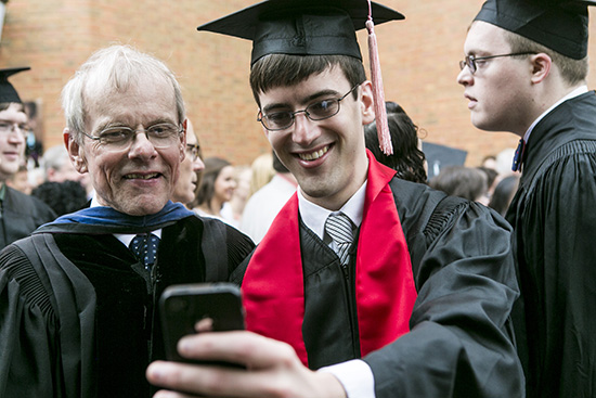 graduate taking selfie with professor