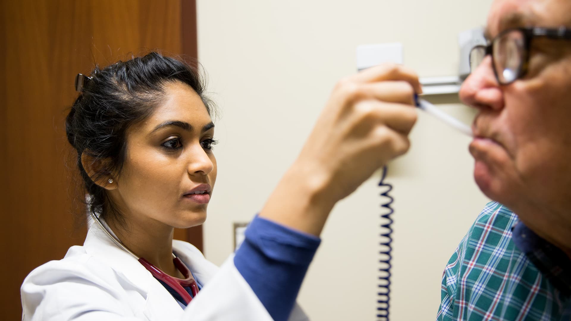 Nurse taking patient's temperature