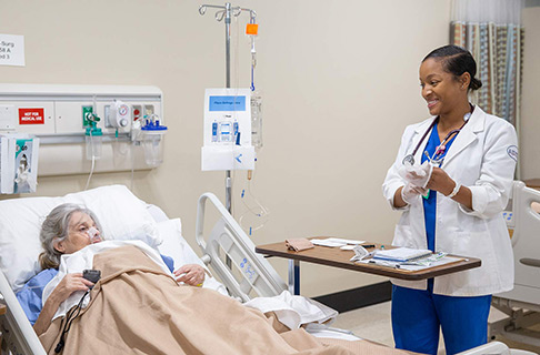 female nursing student with patient cta