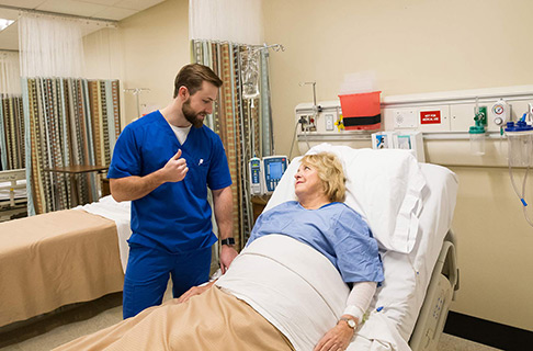 male nursing student with patient cta