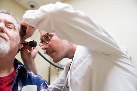 residency student examining patient ear