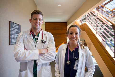 smiling male and female nursing students