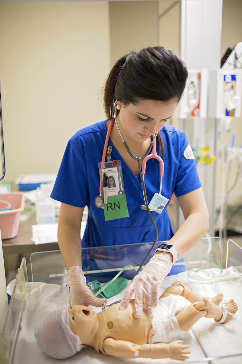 Student practicing on nursing mannequin