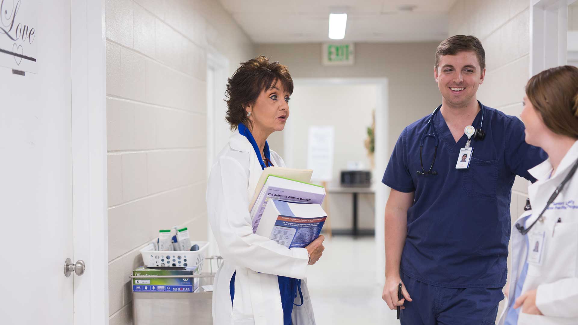 male nursing student speaking with two women