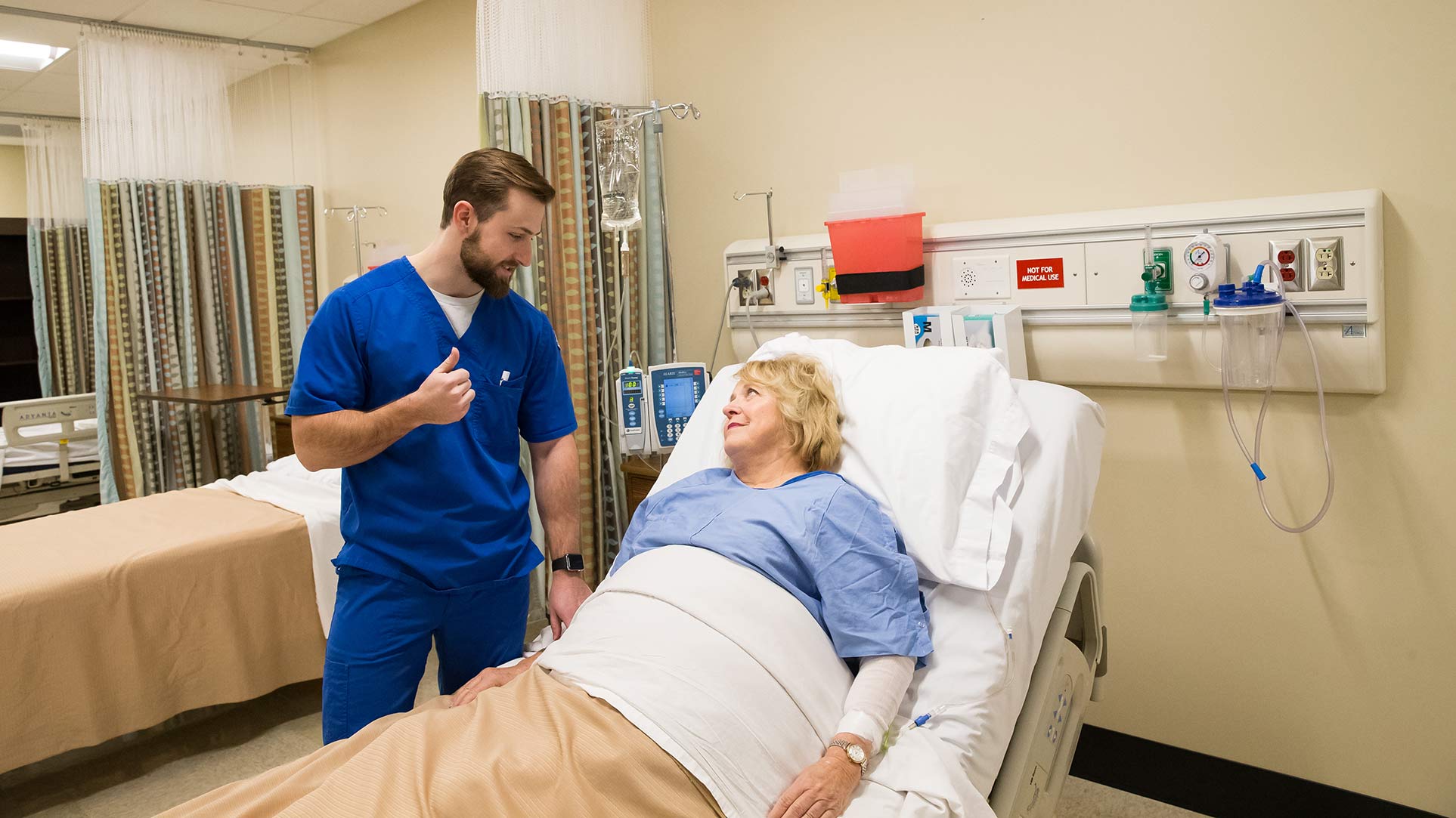 male nursing student with patient