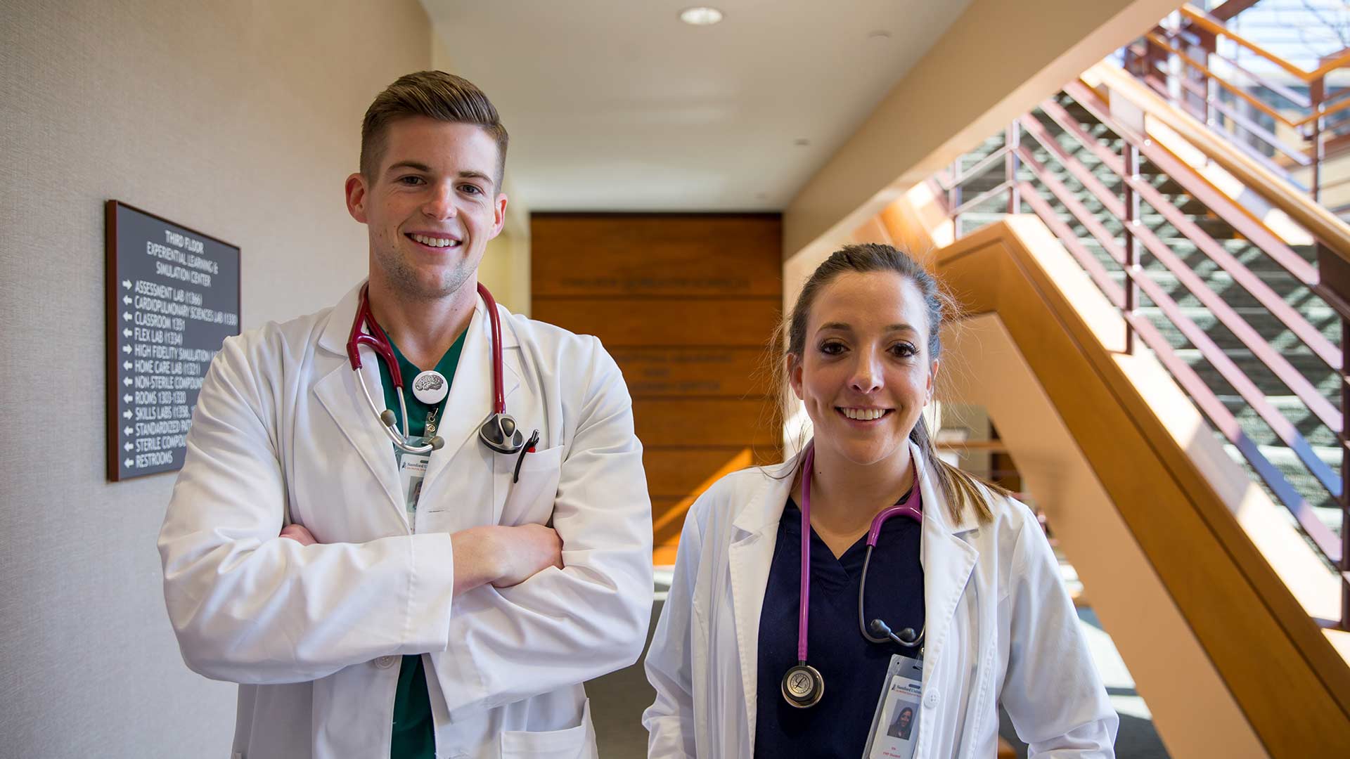 male and female nursing students outside suite