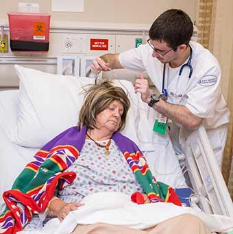 nursing student adjusting breathing tube