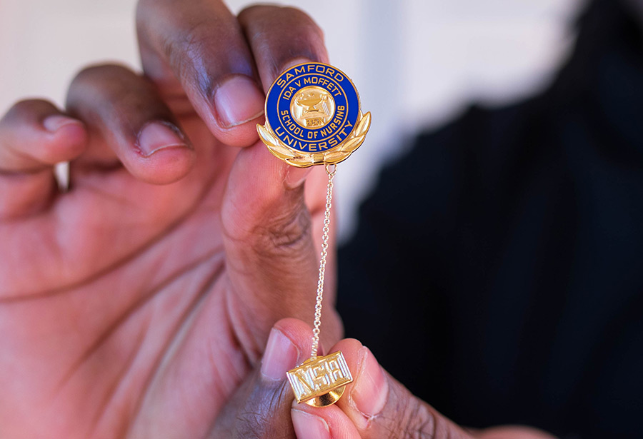 Nursing Student Holding Pin