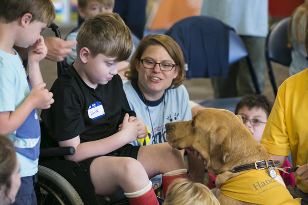 young boy meets dog in CampUs event