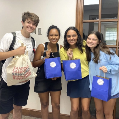 students holding care packages