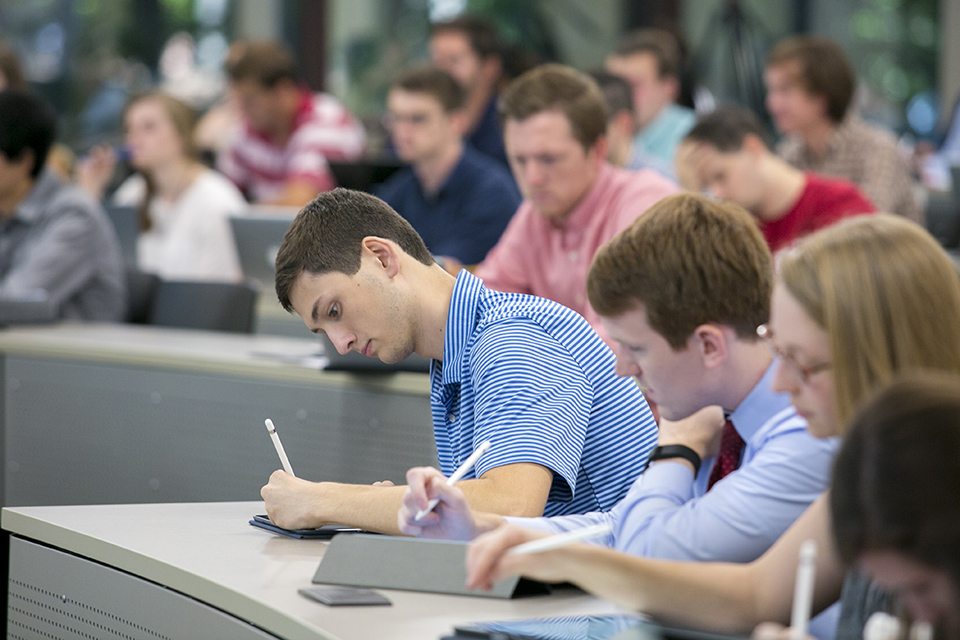 Pharmacy student using an iPad in class