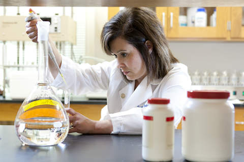 Woman working with beaker