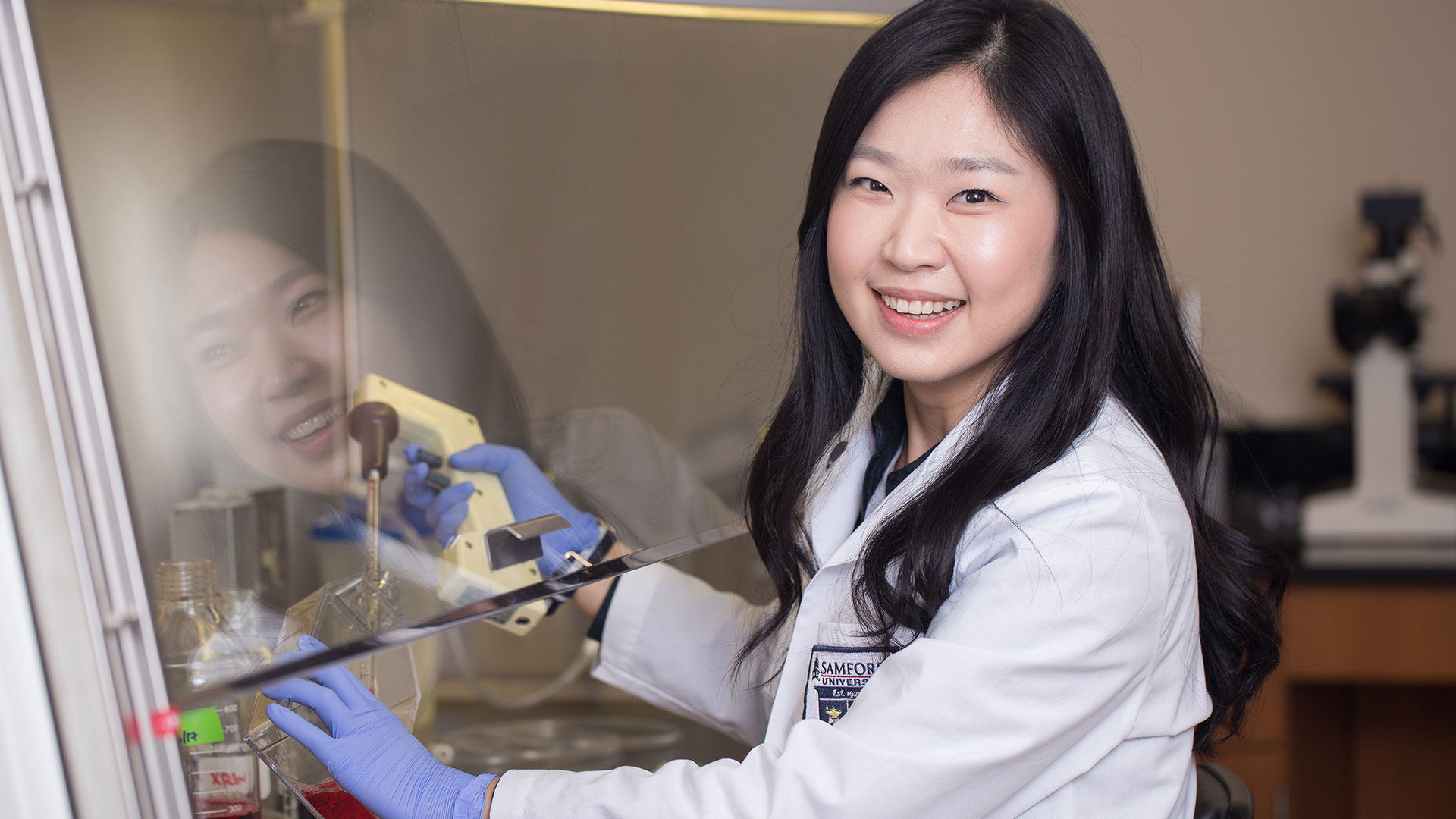 Asian woman pharmacy student experimenting