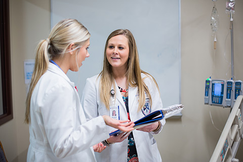 female students discussing chart