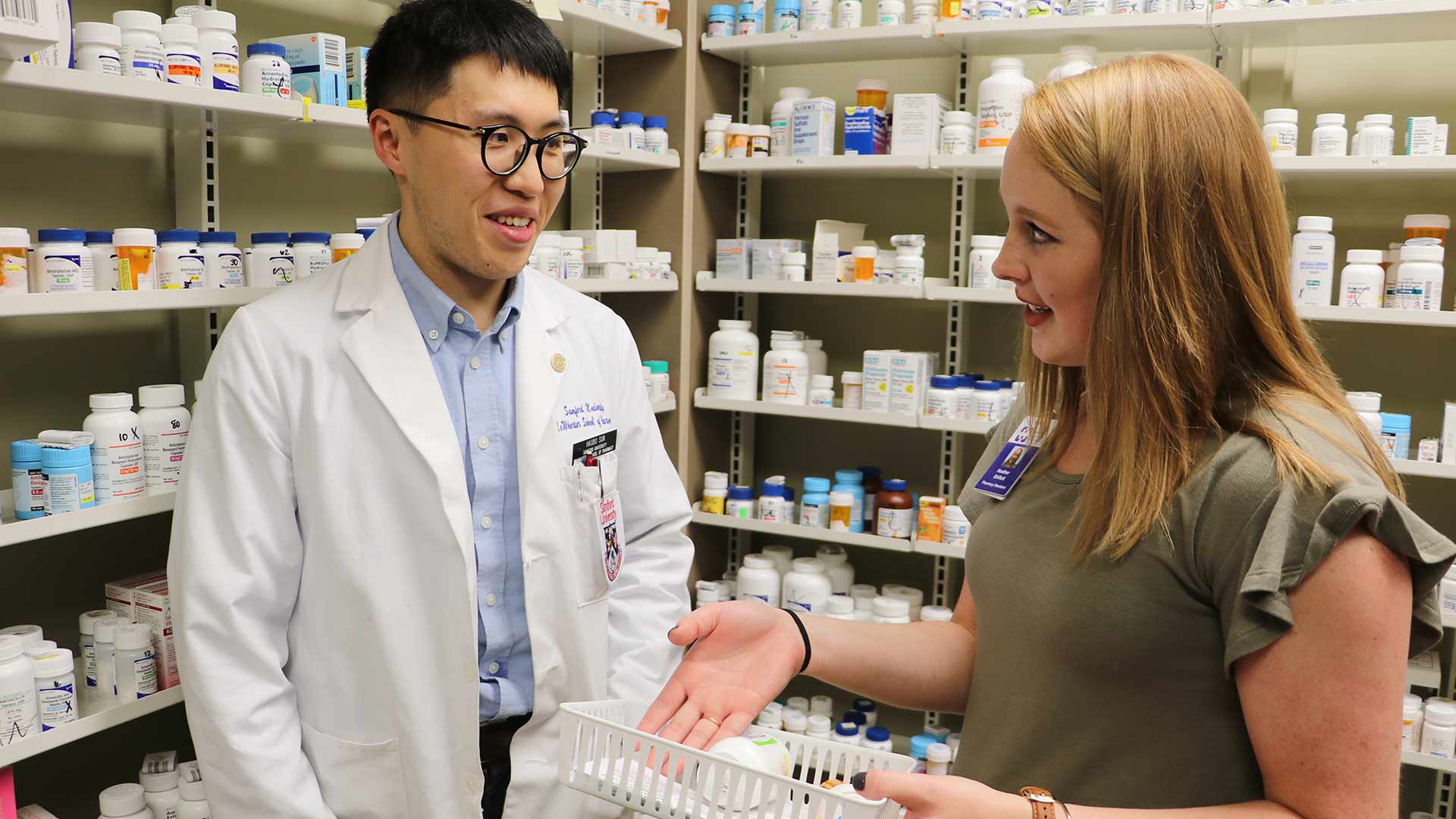 male and female pharmacy students discuss practice