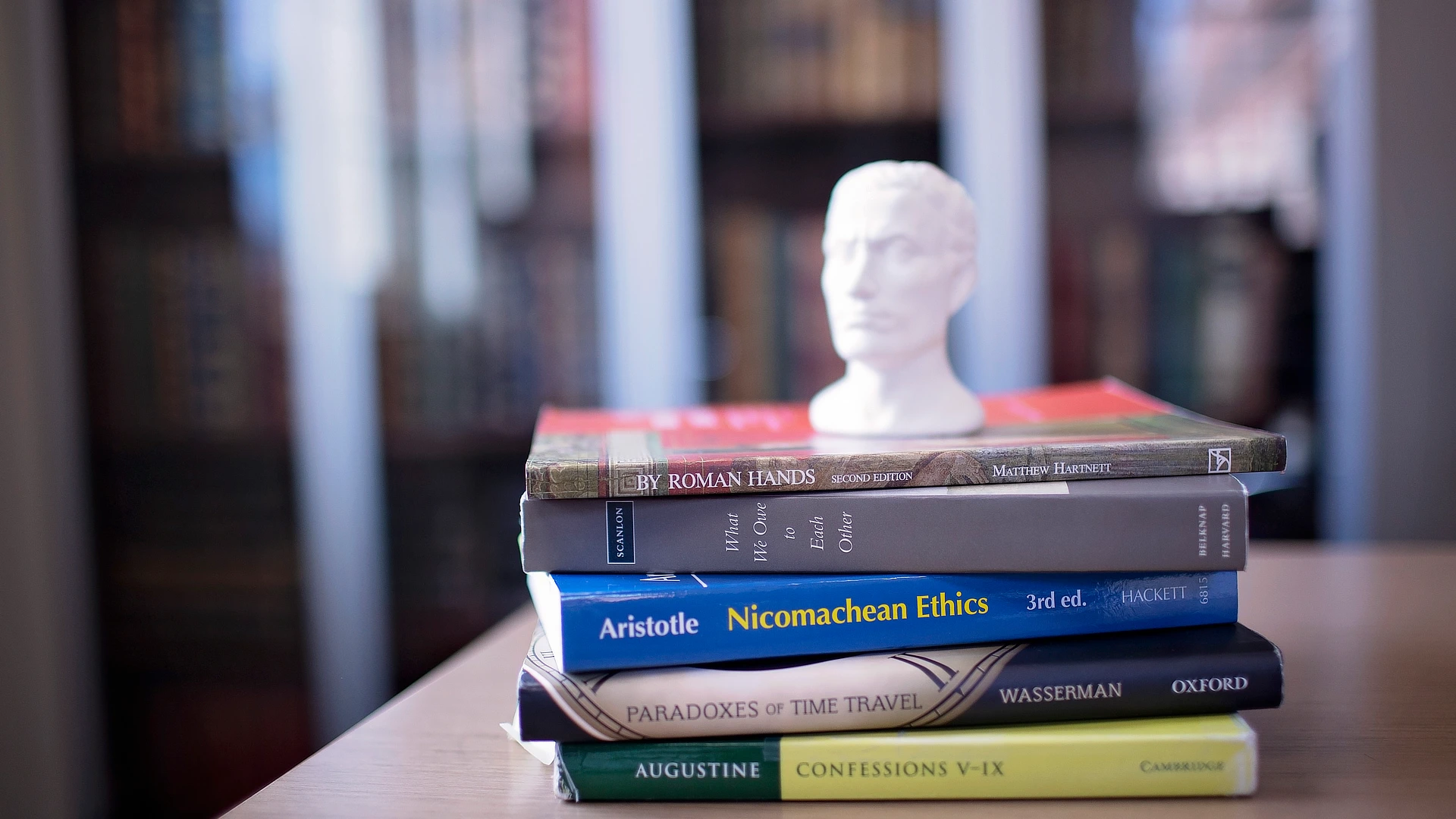 Statue Sitting On Top of Books