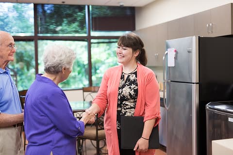 Social worker shaking hands with patient