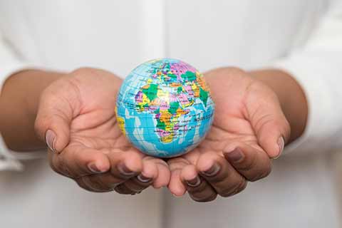 hands holding small globe