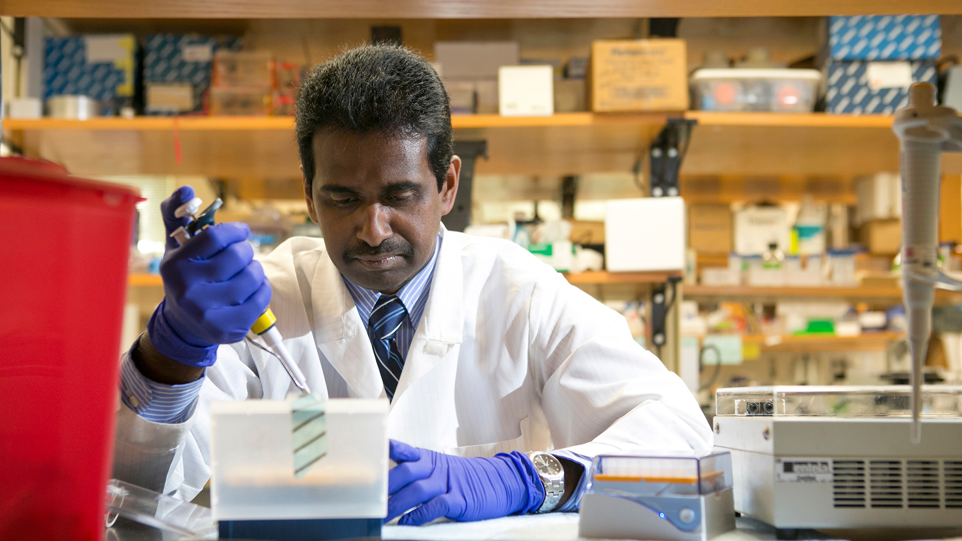 Suresh Mathews working in research lab header