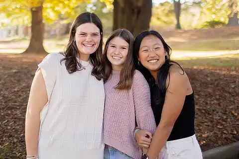 Three Female Students Standing In The Quad