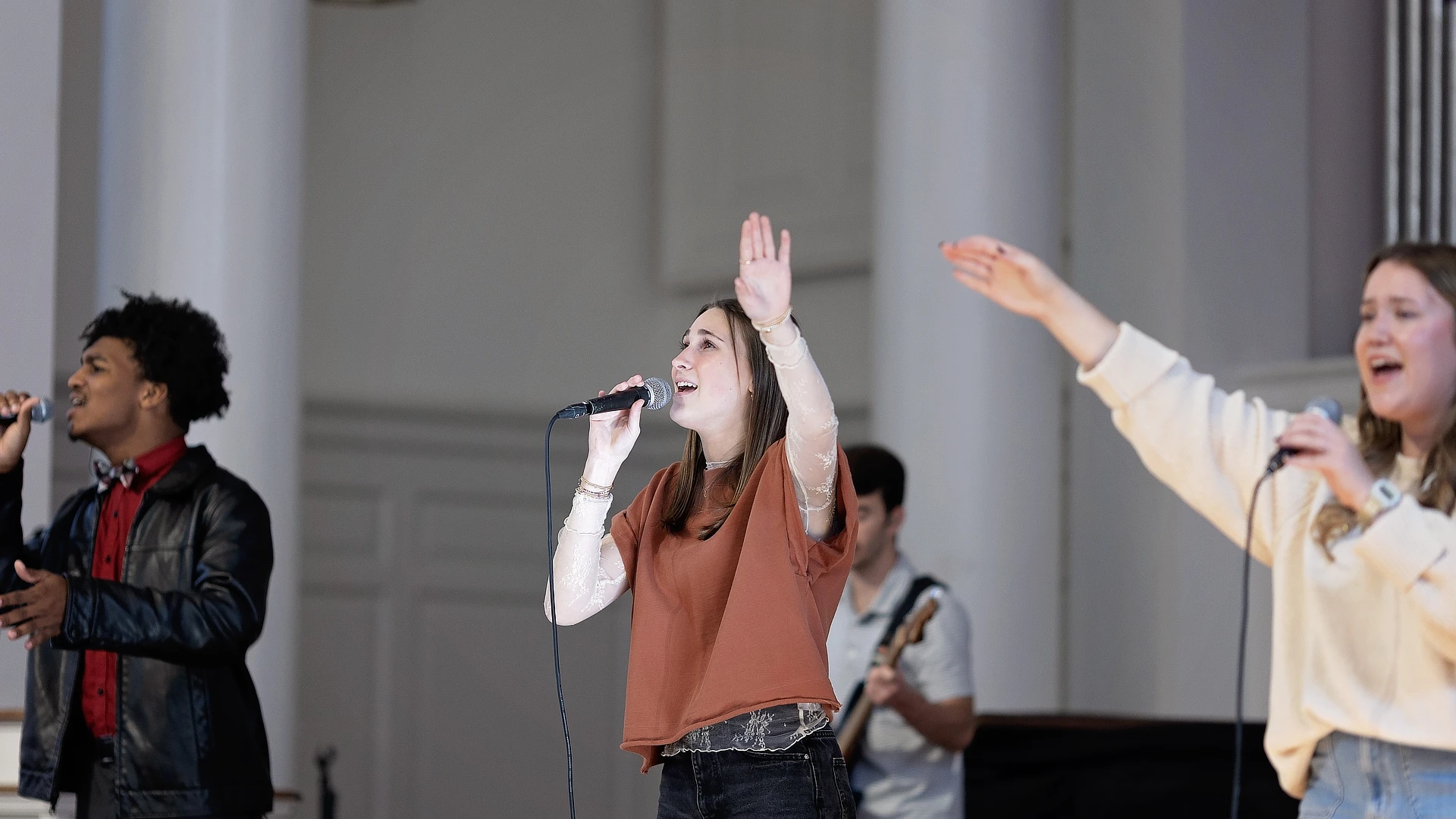 three students leading worship