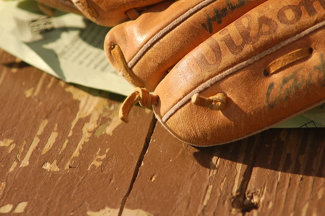 baseball glove on textured wood