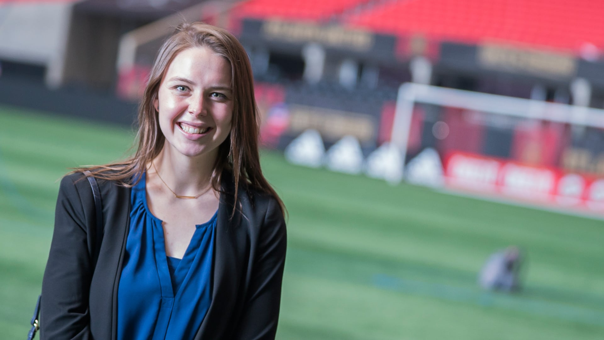 Female Sports Marketing Student on Field