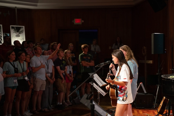 Two Females Students Leading Worship Service