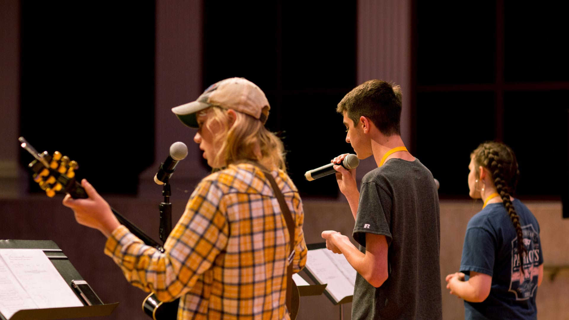three students leading worship