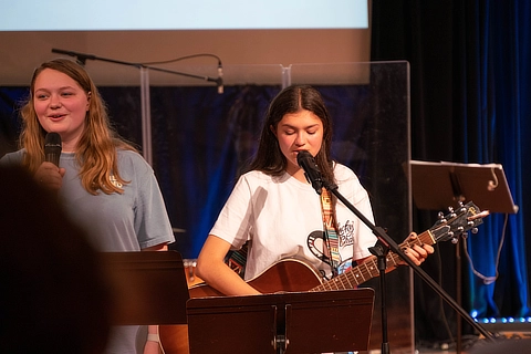 Two Female Students Leading Worship Service